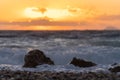 Sea Ã¢â¬â¹Ã¢â¬â¹wave at sunset hitting rock on the beach